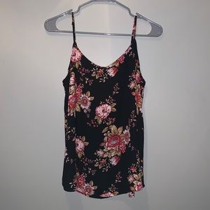 This is a black tank top with a pink floral design
